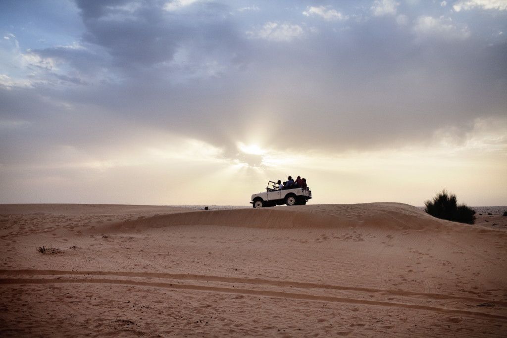 Adventure_Desert Safari_Car on dune sunset